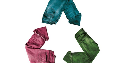 A Recycling symbol made from jeans colored blue, green, and pink.