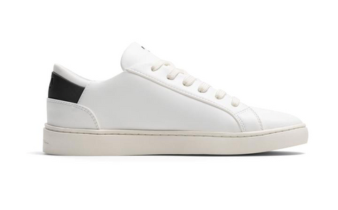 A white casual sneaker with a small black strip at the back.
