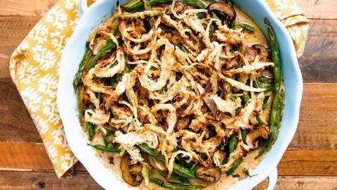 A bowl of green bean casserole with crispy onions on top.