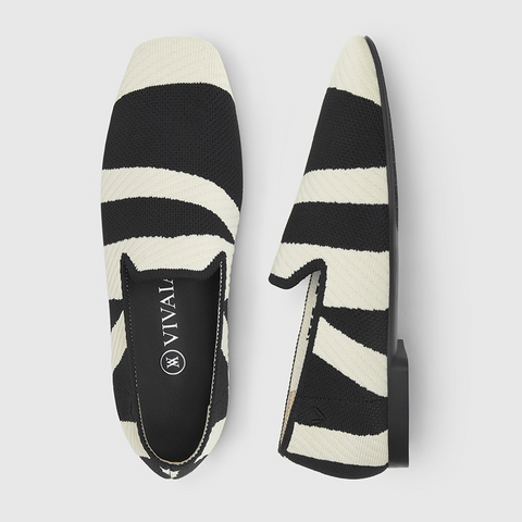 Black and white striped loafer shoes with the Vivaia logo printed in white letters on the insole.