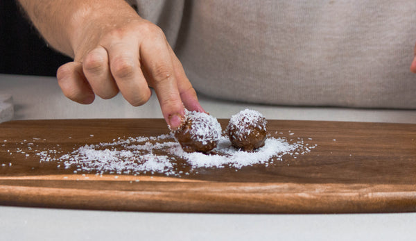 roll hemp protein balls in coconut