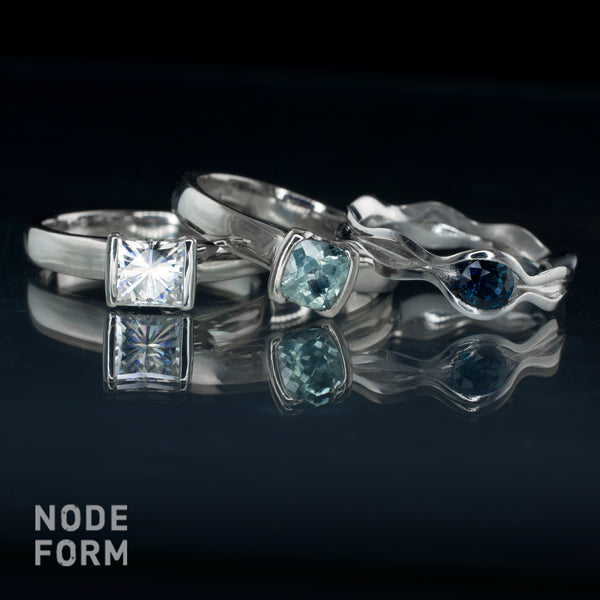 Fair trade cushion sapphire and princess moissanite palladium engagement rings