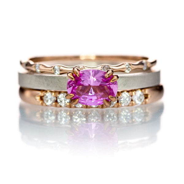 Ring stack with a oval pink sapphire center and rose gold diamond bands