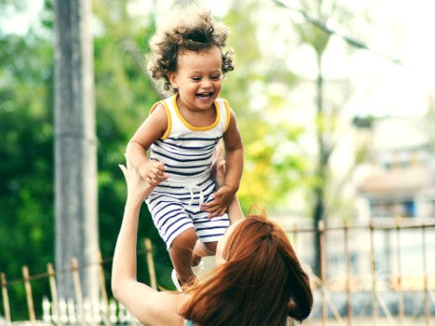 happy kid carried by the mother