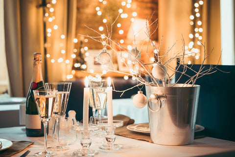 9 Details To Prep Your Home For Your Holiday Party holiday table with twinkle lights and champagne