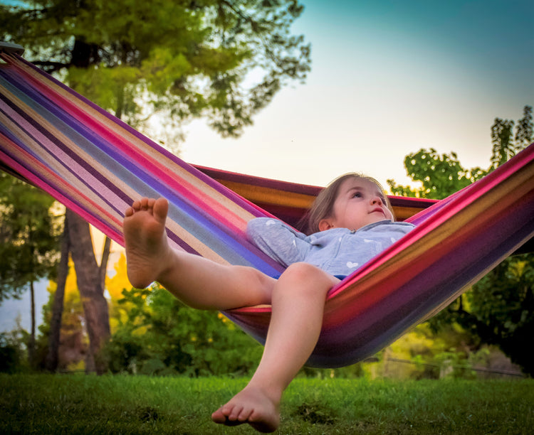 a girl on a color-striped zupapa hammock