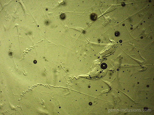 gas bubble inclusions moldavite close up microscope