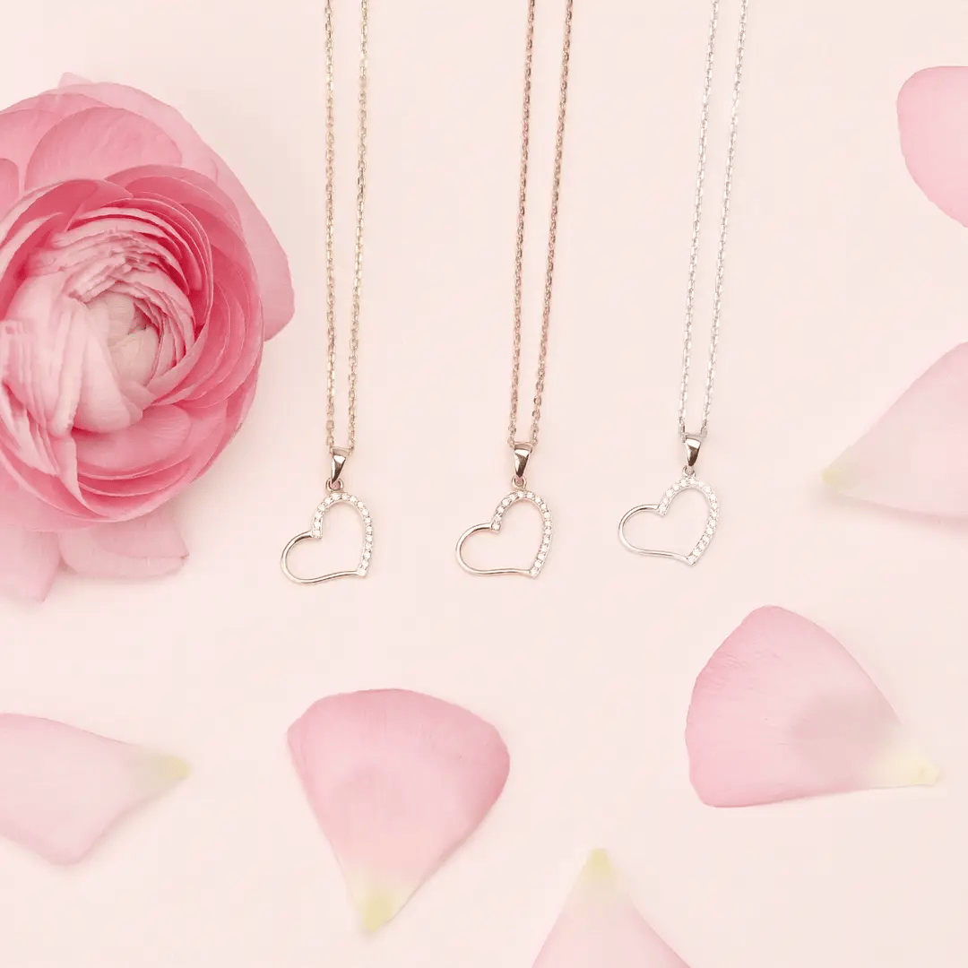 three heart-shaped necklaces with diamonds