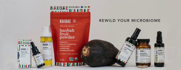 KAIBAE microbiome Wellness Product line lined up with a Baobab pod in the center.  KAIBAE products are powered by Baobab and wild plants to balance the microbiome from gut to skin. 