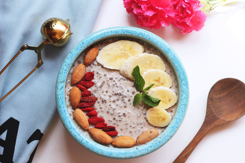 A breakfast smoothie bowl of organic superfoods including baobab fruit powder, berries and whole foods to restore gut microbiome balance. 