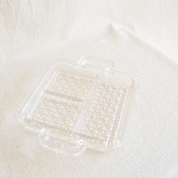 clear glass tray with three sections and small handles