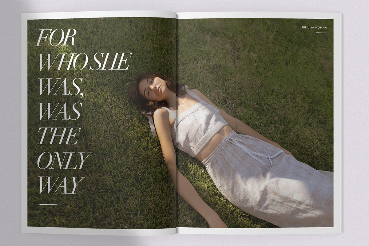 Malia Campau lies on the grass wearing LILYA linen crop top and linen plaid skirt @maliacampau