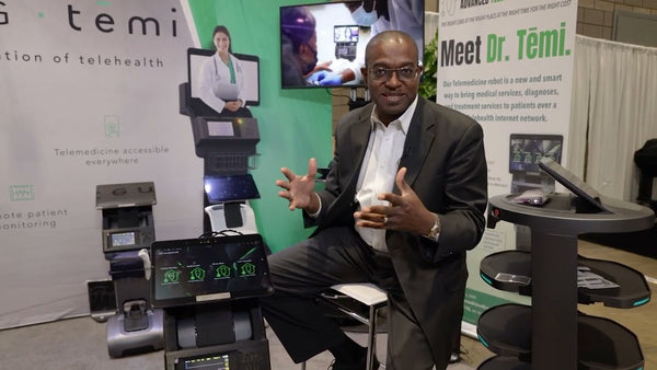 Dr Temi creator sitting with the robot