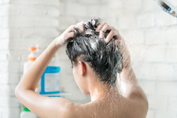 woman showering with good shampoo lather