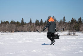 Action Photography: Men's Excursion Ice Pro Bib Pant performing IRL 2