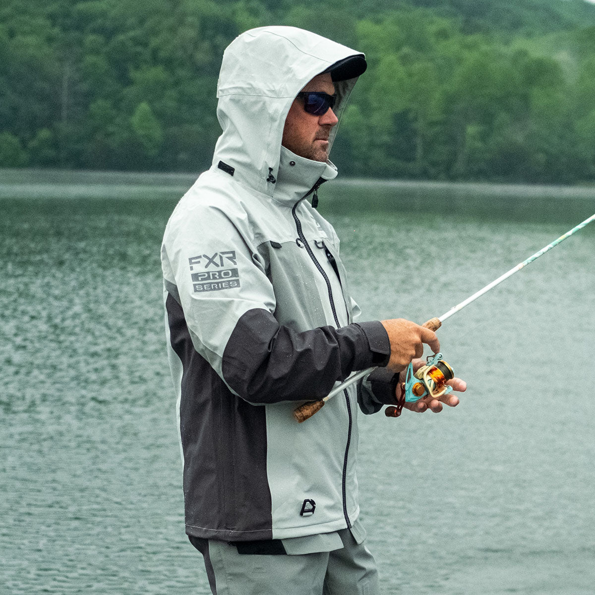 Image of a guy out musky fishing, wearing FXR’s men’s grey charcoal Vapor Pro Tri-laminate Jacket.