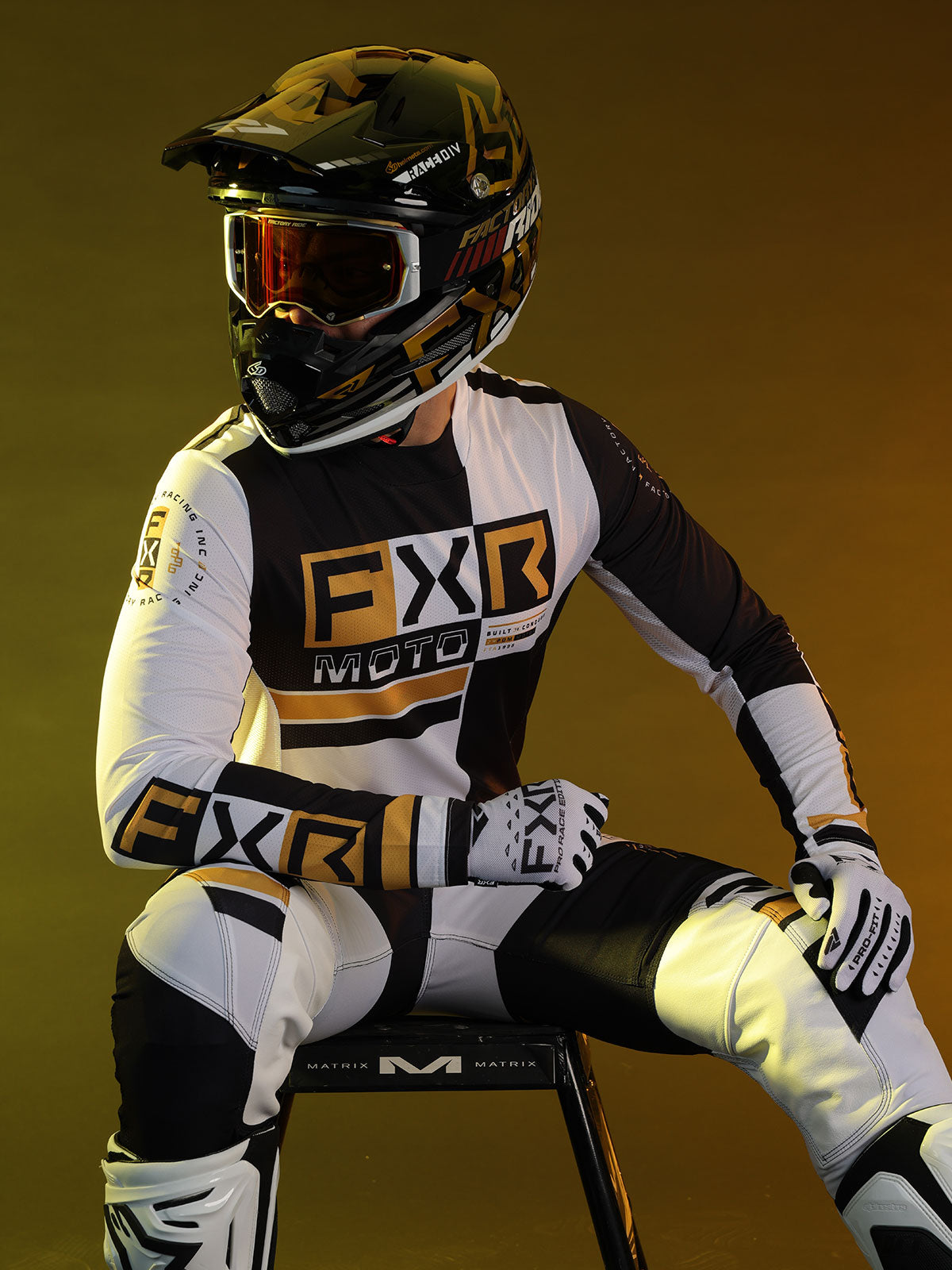 Creative studio shot of a guy in FXR's Battalion jersey and pant in black/white colorway