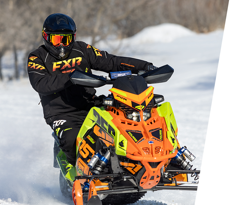 Image of a guy snowmobiling and wearing FXR's Men's Octane jacket