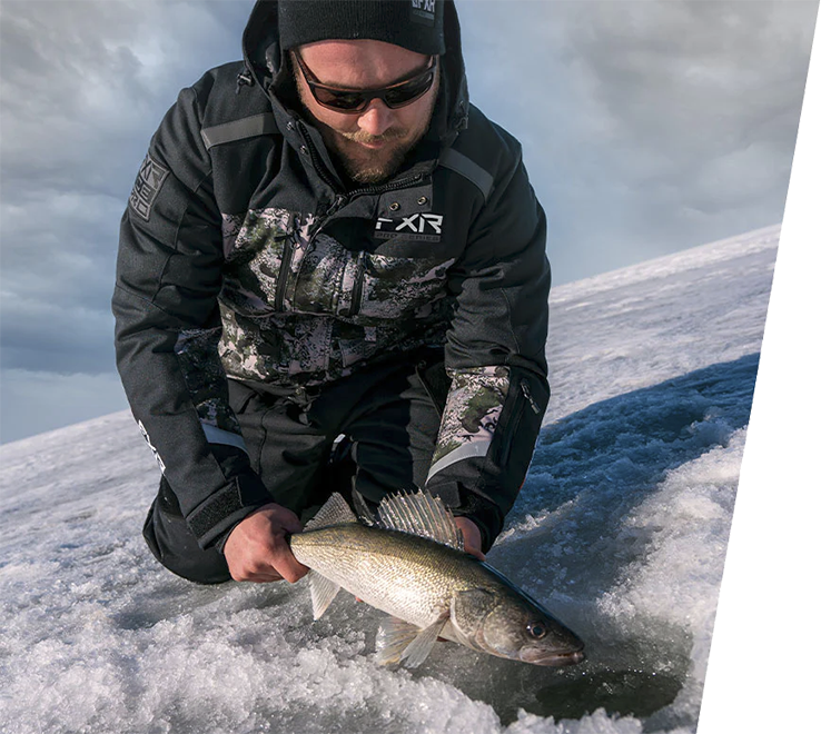 Image of a guy snow fishing sporting FXR's Men's Expedition X Ice Pro Jacket