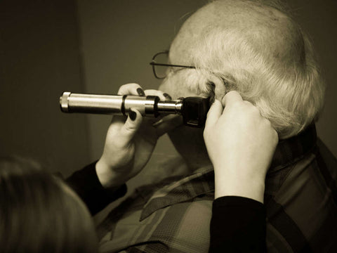 Man having his ears checked by an audiologist