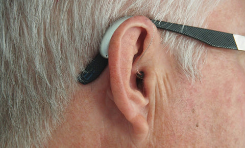 Older man with behind-the-ear hearing aid