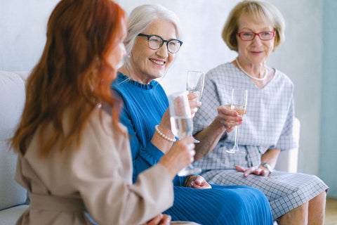 3 ladies chatting with a glass of sparkling wine