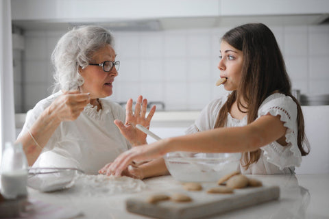 Grandmother and grandaughter baking cookies