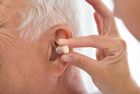 Atom 2 Series being inserted in a man's ear