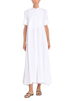 An image of a model wearing a long, white cotton poplin shirt dress. 
