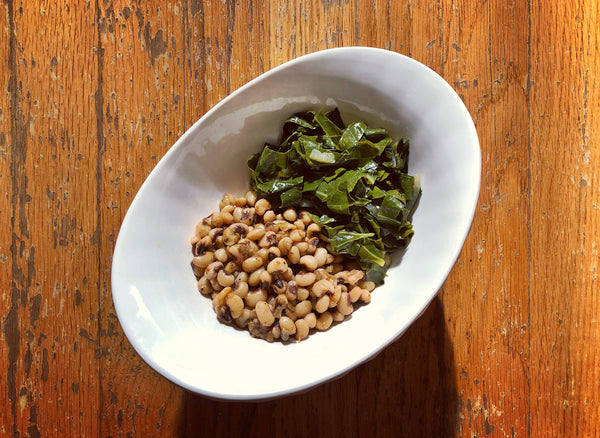 a bowl of braised collards and black-eyed peas