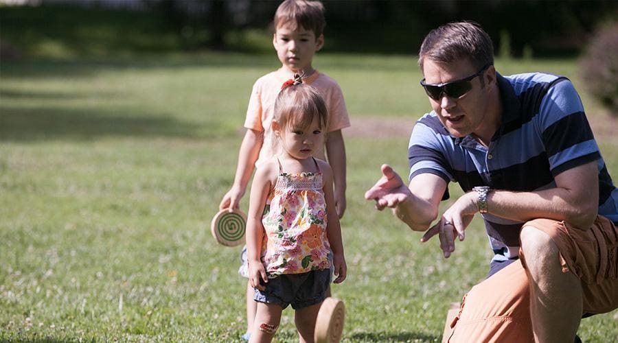 a group of people playing frisbee in a park