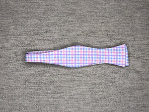 Pink and light blue gingham on a white bow tie