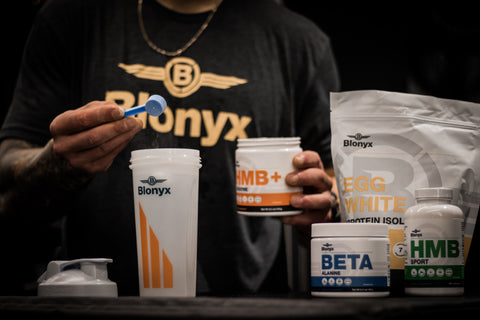 sports nutrition supplements poured into shaker bottle