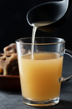 bone broth poured in glass