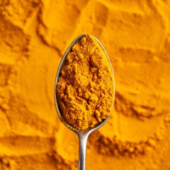 turmeric powder in a spoon