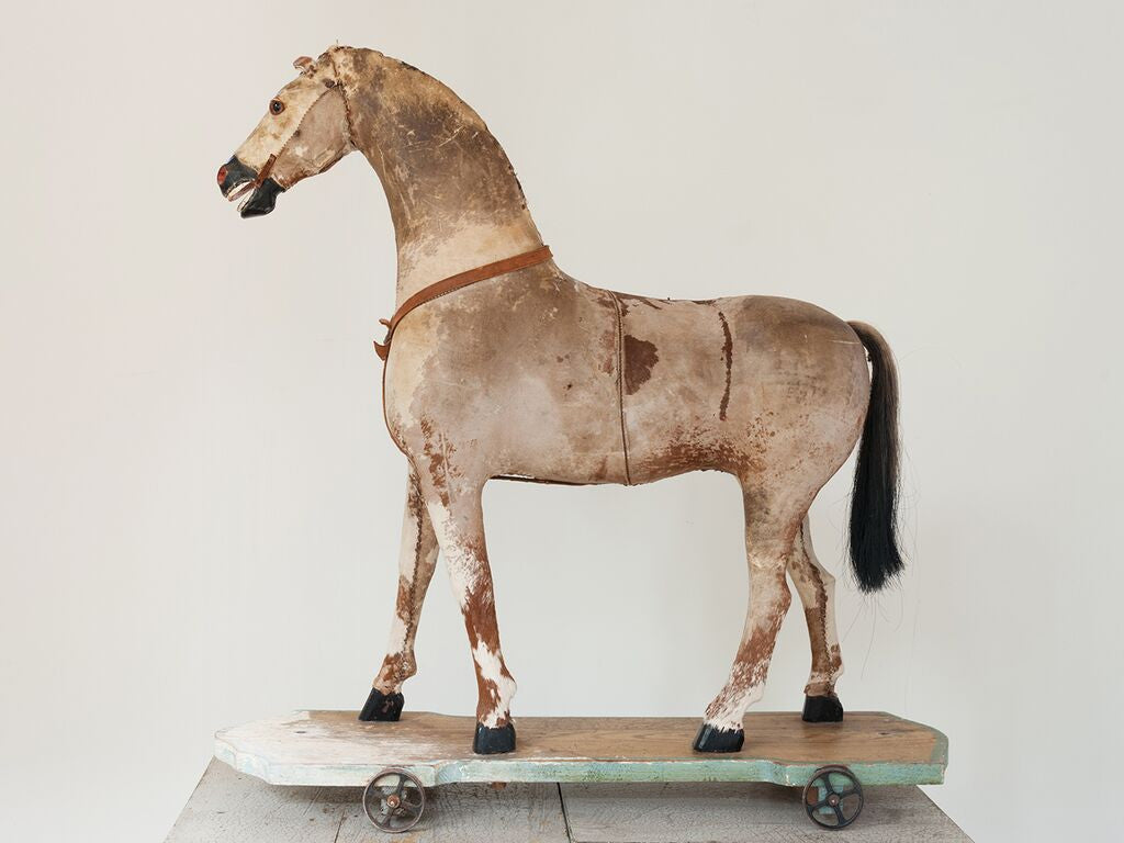 antique toy horse on wheels