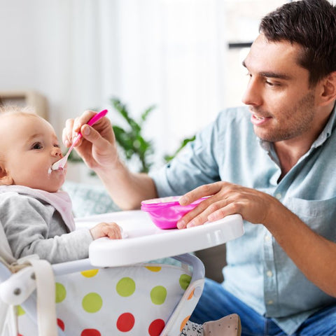 father feeds the baby