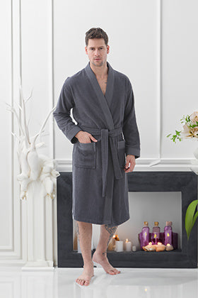 A sophisticated man relaxing in a SEYANTE men’s kimono robe