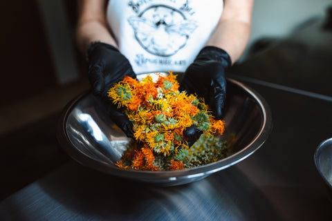 BBA founder mixing botanicals grown on their family farm for use in their all natural artisan skincare concentrates.