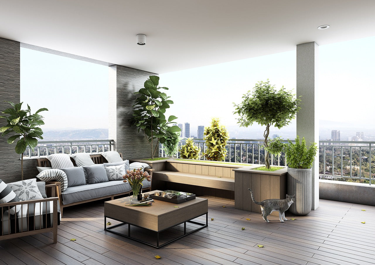 A serene balcony scene with outdoor furniture sets and lush green plants on a sunny day