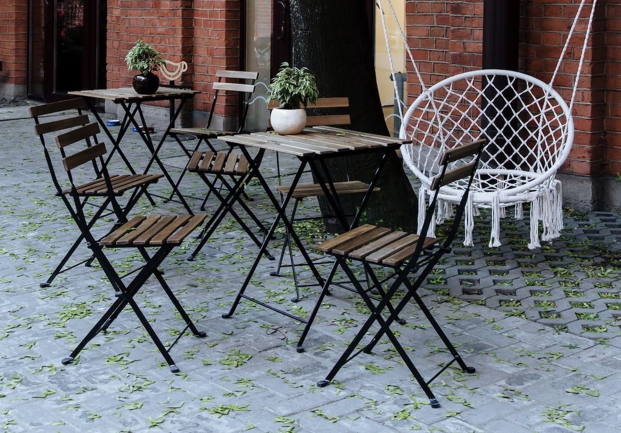 A wooden table and chair are placed outside the door