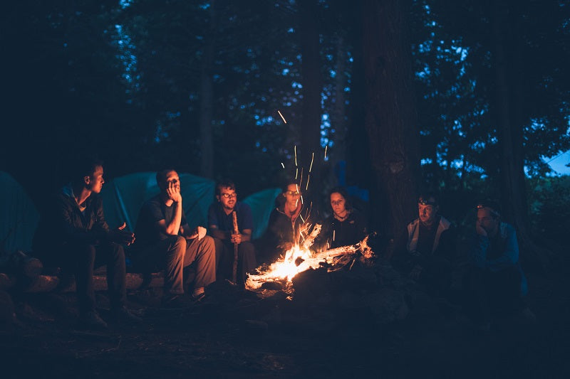 On summer nights, friends get together to have a bonfire party and relax