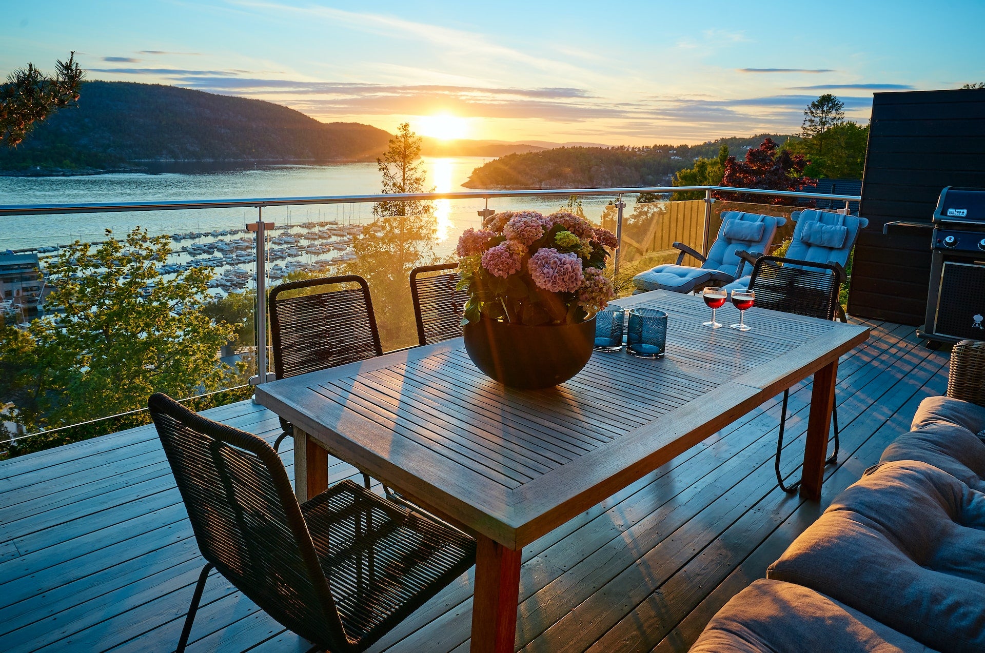 The sun was setting over the lake and the patio furniture was in front of me