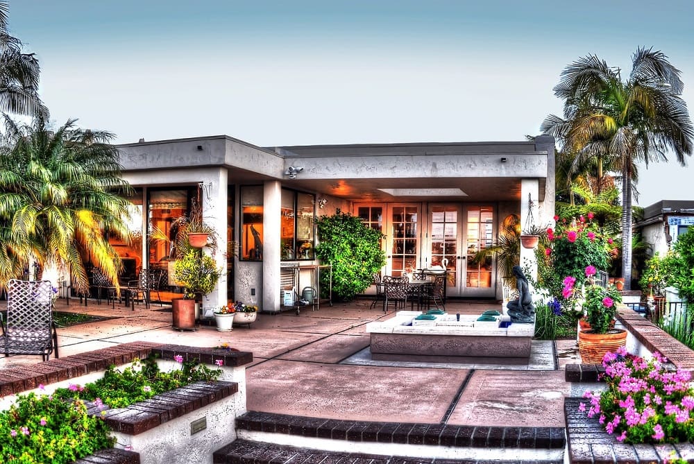 the outdoor patio is warm with green trees and chairs