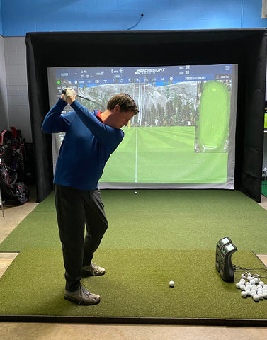 Marc in his backswing in an indoor golf simulator with Launch Pro and GC3 launch monitors