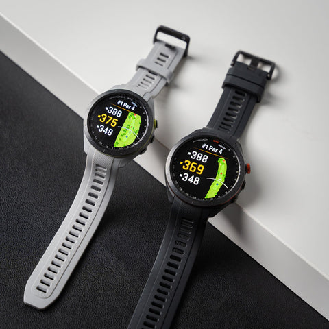 Gray 42 mm and black 47 mm Garmin Approach S70 golf watches side by side with distances and image of the green on the AMOLED screens