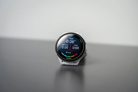 The Garmin Forerunner 165 with GPS distance, pace, time, and heart rate on the display