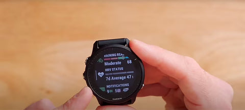 A black Garmin Forerunner 955 with HRV status on the display