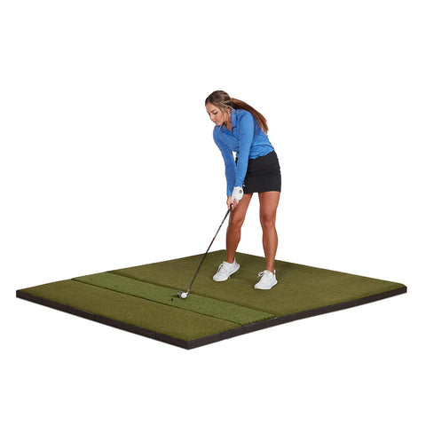 Woman swinging on a Fiberbuilt golf mat