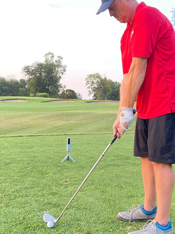 Our golf reviewer of this article, Marc, with the Rapsodo MLM2PRO set up behind him getting ready to take a shot